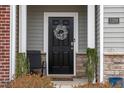 Modern black front door accented with a stylish wreath at 1109 Banworth Ct, Mebane, NC 27302