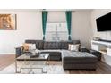 Spacious living room featuring a sectional sofa and large TV at 1109 Banworth Ct, Mebane, NC 27302