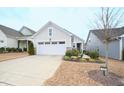 Charming one story home with a two car garage, light siding, and well manicured front yard at 125 Canary Ct. Ct, Raleigh, NC 27610