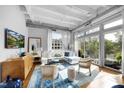 Spacious living room with hardwood floors and access to a balcony at 1300 St Marys St # 404, Raleigh, NC 27605