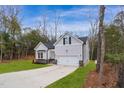 Newly built home with gray siding, stone accents, and a two-car garage at 138 Mayan Dr, Louisburg, NC 27549