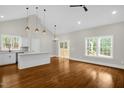 Open concept kitchen with island, hardwood floors, and modern appliances at 138 Mayan Dr, Louisburg, NC 27549