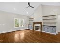 Spacious living area featuring hardwood floors, a fireplace, and built-in shelving at 138 Mayan Dr, Louisburg, NC 27549