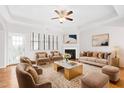 Bright living room featuring a fireplace, ceiling fan, plush seating, and neutral decor at 1400 Basley St, Wake Forest, NC 27587