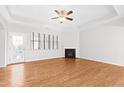 Open-concept living room featuring hardwood floors, a fireplace, and abundant natural light at 1400 Basley St, Wake Forest, NC 27587