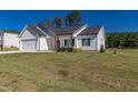 White and gray sided home with a two-car garage and landscaping at 16 Sourgum Ct Ct, Zebulon, NC 27597