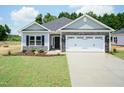 Inviting single-story home with stone accents, a two-car garage, and freshly laid green grass at 1701 Drayton Hall Ln, Sanford, NC 27330
