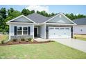 Beautiful single-story home with a two-car garage and a meticulously landscaped front yard at 1701 Drayton Hall Ln, Sanford, NC 27330