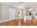 Bright living room with hardwood floors and view into kitchen at 1712 Rosetta Dr, Durham, NC 27701