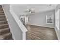 Bright living room with hardwood floors and a view of the kitchen at 201 Brickwell Way, Youngsville, NC 27596