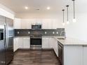 Modern kitchen with stainless steel appliances and granite countertops at 2325 Gathering Square Ct Ct # 2325, Fuquay Varina, NC 27526