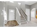 Bright entryway with stairs, wood-look floors, and neutral walls at 2901 Alder Ridge Ln, Raleigh, NC 27603