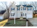Charming two-story home with neutral siding, black shutters, and an attached two-car garage at 2901 Alder Ridge Ln, Raleigh, NC 27603