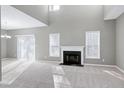 Spacious living room with a fireplace, high ceilings, and neutral decor at 2901 Alder Ridge Ln, Raleigh, NC 27603