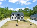 New construction home featuring black trim, a well maintained lawn, and ample parking in the driveway at 320 Pilot Ridge Rd, Zebulon, NC 27597