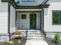 Elegant front porch with stone stairs and black metal railings welcomes you to this meticulously maintained home at 320 Pilot Ridge Rd, Zebulon, NC 27597