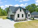 Well maintained home with a spacious driveway, a two-car garage, and well-manicured lawn at 320 Pilot Ridge Rd, Zebulon, NC 27597
