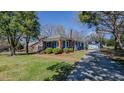 Beautiful blue home featuring a detached garage and manicured landscaping at 420 Parkview Dr, Burlington, NC 27215