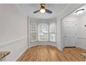 Bright dining area featuring wood floors, bay window, and ceiling fan with traditional decor at 4541 Hershey Ct, Raleigh, NC 27613