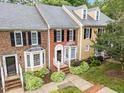 Aerial view of well-maintained townhomes with manicured lawns and mature trees, boasting classic architectural details at 4541 Hershey Ct, Raleigh, NC 27613