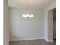 Dining room features modern chandelier and neutral color palette, perfect for entertaining at 53 Priming Way, Angier, NC 27501