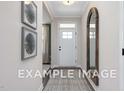 Bright entryway with wood-look floors and a large mirror at 53 Priming Way, Angier, NC 27501