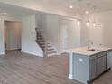 Open-concept kitchen with modern island that flows into the adjacent living space at 53 Priming Way, Angier, NC 27501