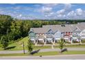 Wide shot of townhome community, highlighting the street and surrounding landscape at 705 Traditions Grande Blvd, Wake Forest, NC 27587