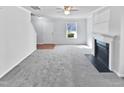 Spacious living room featuring gray carpeting and a fireplace at 83 Valleyfield Dr, Clayton, NC 27527