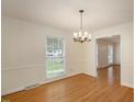 Formal dining room with hardwood floors and a chandelier at 908 Glen Eden Dr, Raleigh, NC 27612