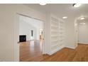 Built-in shelving and hardwood floors in library with access to Gathering room at 908 Glen Eden Dr, Raleigh, NC 27612