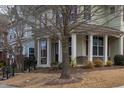 Brick and siding two-story house with covered porch and landscaping at 9306 Alcazar Walk, Raleigh, NC 27617