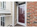 Townhouse entry with glass storm door and brick surround at 10310 Sablewood Dr # 108, Raleigh, NC 27617