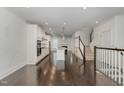 Open concept kitchen with island, stainless steel appliances, and hardwood floors at 10310 Sablewood Dr # 108, Raleigh, NC 27617
