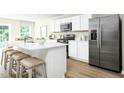 Modern kitchen with white cabinets, stainless steel appliances, and an island at 104 Cavalier Rider Run, Wendell, NC 27591