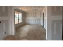 A bright, spacious living room with large windows that let in plenty of natural light at 110 Tennyson Dr, Garner, NC 27529