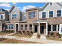 Well-maintained townhomes boasting brick and siding exteriors and tidy landscaping at 284 Chesapeake Commons St # 150, Garner, NC 27529