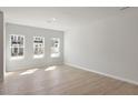 Spacious open-concept living room featuring wood-look floors and natural light at 284 Chesapeake Commons St # 150, Garner, NC 27529