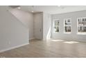 Bright living room featuring wood-look floors, fresh paint, and natural light at 284 Chesapeake Commons St # 150, Garner, NC 27529