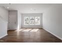 Bright living room with hardwood floors, large windows, and neutral paint, creating a welcoming atmosphere at 288 Chesapeake Commons St # 149, Garner, NC 27529