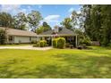 House exterior with a green lawn, and a partially visible neighboring house at 619 Barbour St, Clayton, NC 27520