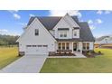 Charming two-story home with a 2-car garage, black accents and neatly manicured lawn at 66 Tennyson Dr, Garner, NC 27529