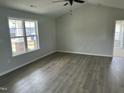 Bright bedroom with vaulted ceiling, wood flooring and large window at 69 N Movado Trl, Kenly, NC 27542