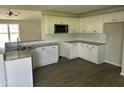 Modern kitchen featuring white cabinets, granite countertops, and stainless steel appliances at 69 N Movado Trl, Kenly, NC 27542