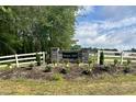 Stone entrance sign to Flower Hill neighborhood with fresh landscaping at 69 N Movado Trl, Kenly, NC 27542