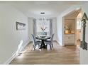 Bright dining room featuring modern chandelier, a round table and a view into kitchen at 707 Wade Ave, Raleigh, NC 27605