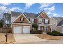 Two-story brick home with a two-car garage and landscaped front yard at 7572 Silver View Ln, Raleigh, NC 27613