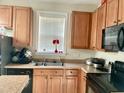 Kitchen with wood cabinets, double sink, and appliances at 814 Providence Glen Dr, Chapel Hill, NC 27514