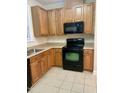 A well-equipped kitchen with wooden cabinets and black appliances at 814 Providence Glen Dr, Chapel Hill, NC 27514