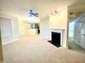 Spacious living room with neutral carpet, fireplace, and ceiling fan at 814 Providence Glen Dr, Chapel Hill, NC 27514